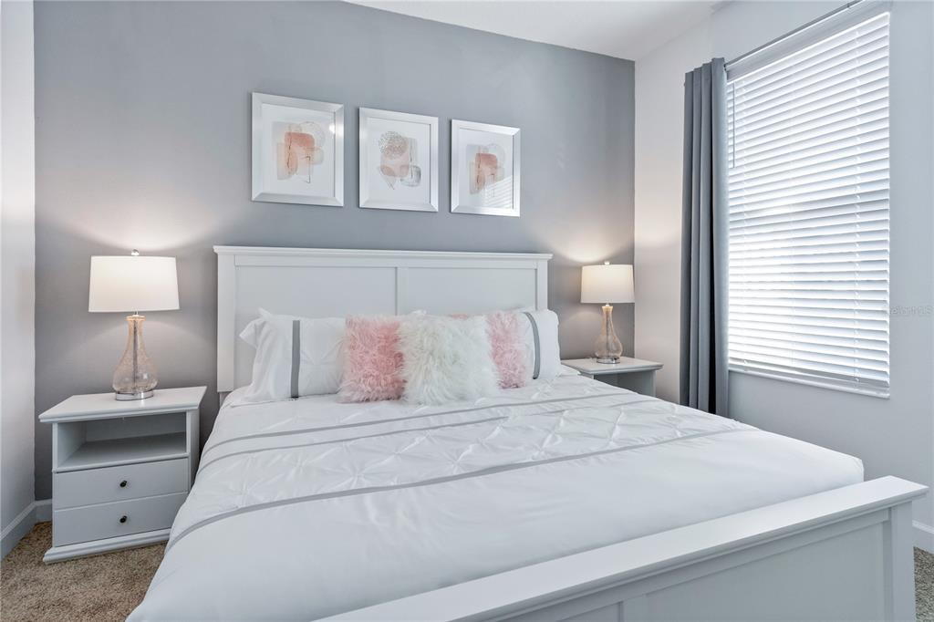 3032 Protagonist Street Kissimmee, FL 34746 - Photo 25 of 34 a bedroom with a bed and a night stand