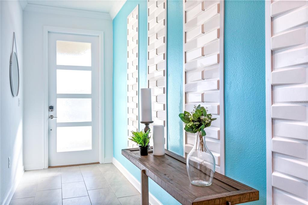 3032 Protagonist Street Kissimmee, FL 34746 - Photo 3 of 34 a view of an entryway with wooden floor and a potted plant