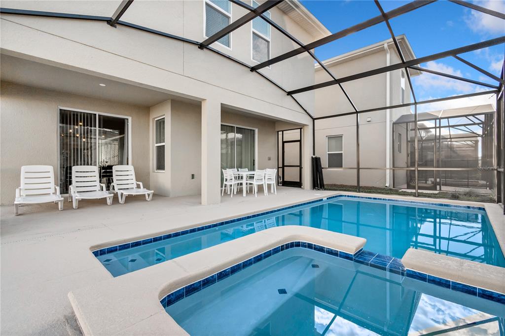 3032 Protagonist Street Kissimmee, FL 34746 - Photo 32 of 34 a bathroom with a tub sink and mirror