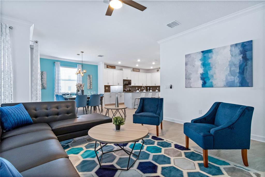 3032 Protagonist Street Kissimmee, FL 34746 - Photo 4 of 34 a living room with furniture and a dining table