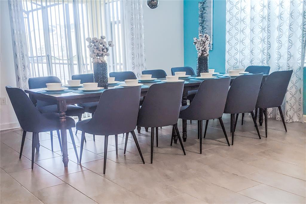 3032 Protagonist Street Kissimmee, FL 34746 - Photo 7 of 34 a view of a dining room with furniture window and outside view