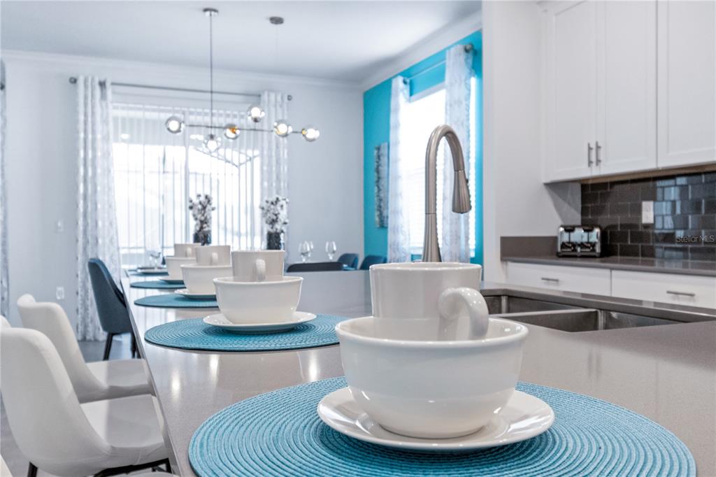 3032 Protagonist Street Kissimmee, FL 34746 - Photo 10 of 34 a living room with couches and a chandelier