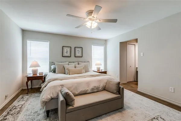 a bedroom with a large bed and a chandelier