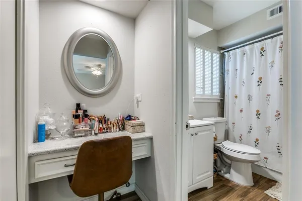 a bathroom with a toilet a sink and a mirror
