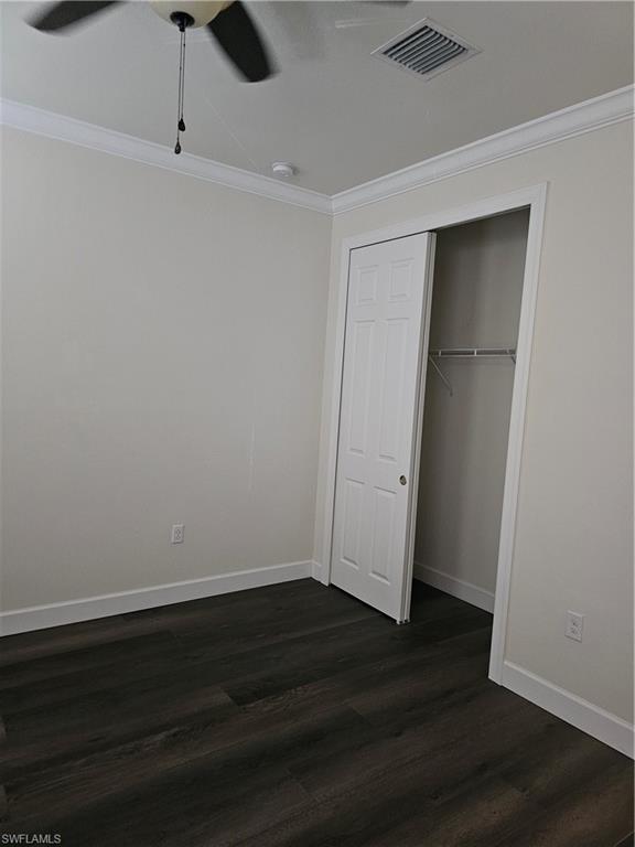 10840 Rutherford Road Fort Myers, FL 33913 - Photo 10 of 35 Spare room featuring dark wood-type flooring, ornamental molding, and ceiling fan