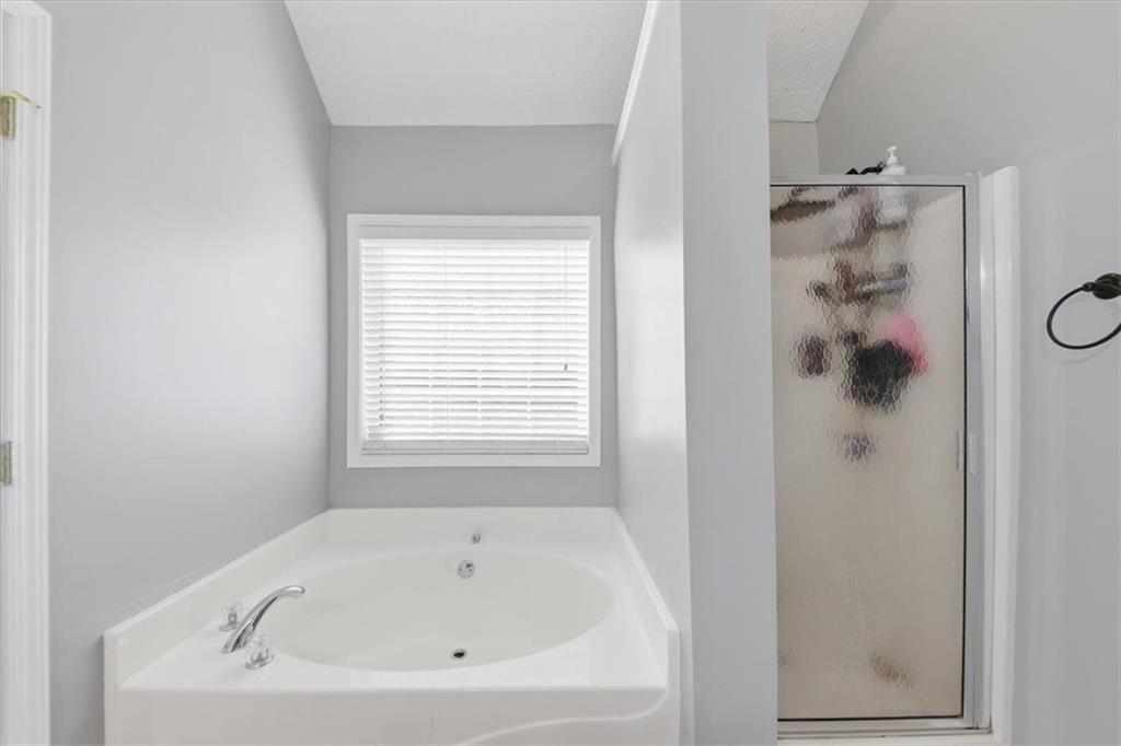 493 Youth Jersey Road Covington, GA 30014 - Photo 31 of 52 a white bath tub sitting next to a shower