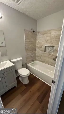 a bathroom with a toilet a sink and bathtub