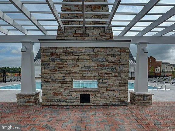 7014 Foxton Way Hanover, MD 21076 - Photo 27 of 29 Charming outdoor fireplace by the pool.