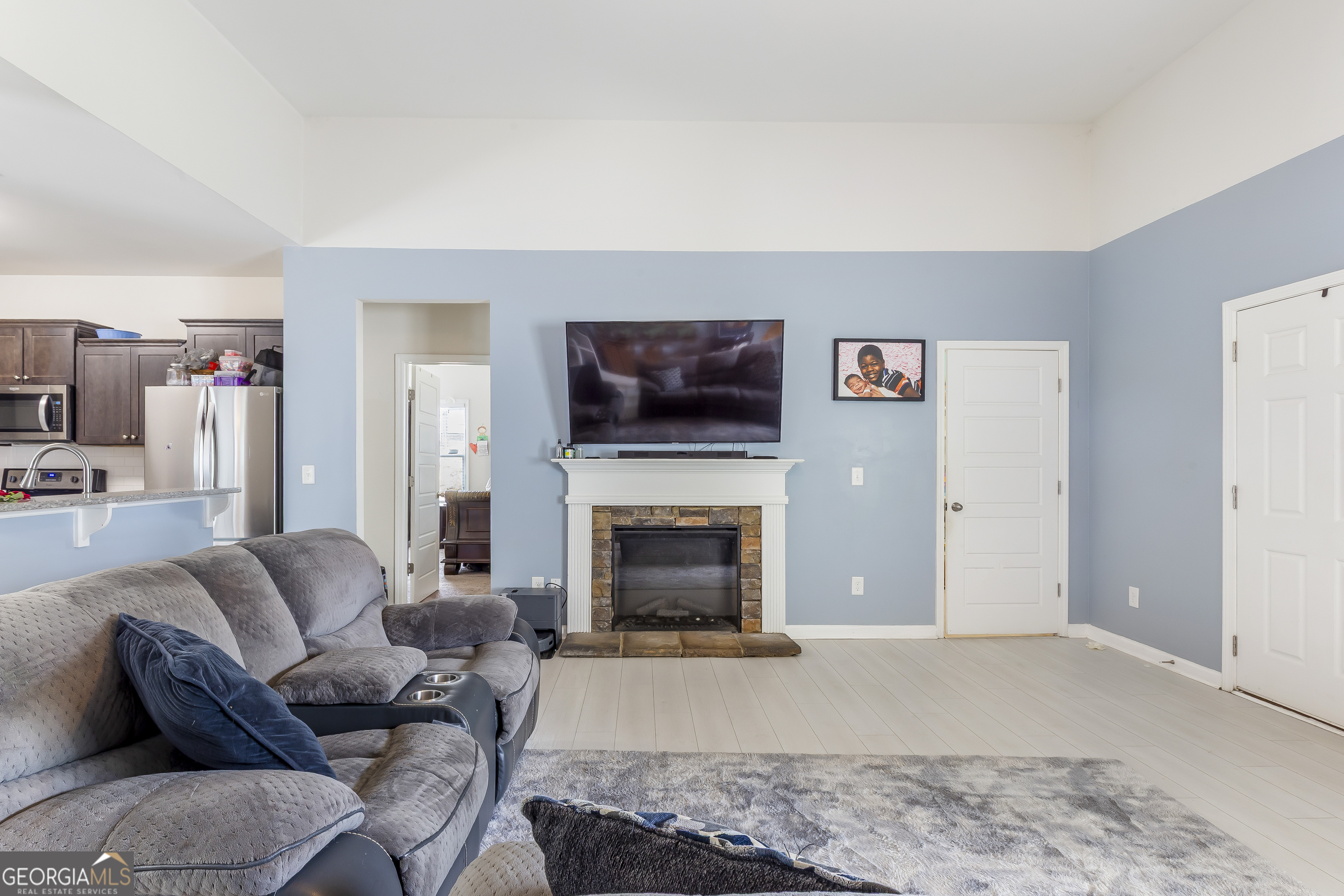 370 Springwater Way Bremen, GA 30110 - Photo 5 of 32 a living room with furniture a fireplace and a flat screen tv