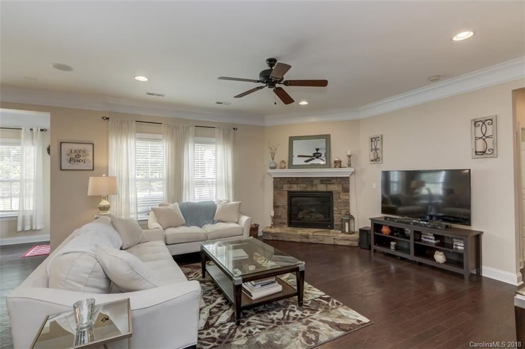 16834 Rudence Court Charlotte, NC 28278 - Photo 14 of 30 a living room with furniture a flat screen tv and a fireplace