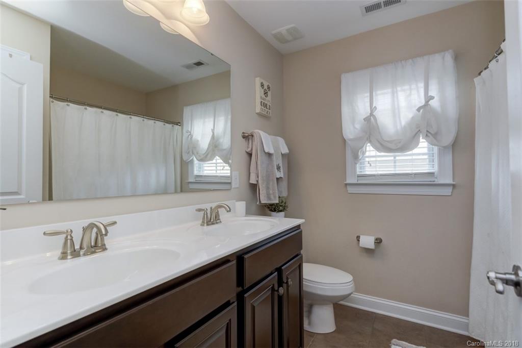 16834 Rudence Court Charlotte, NC 28278 - Photo 22 of 30 a bathroom with a sink a toilet and a mirror