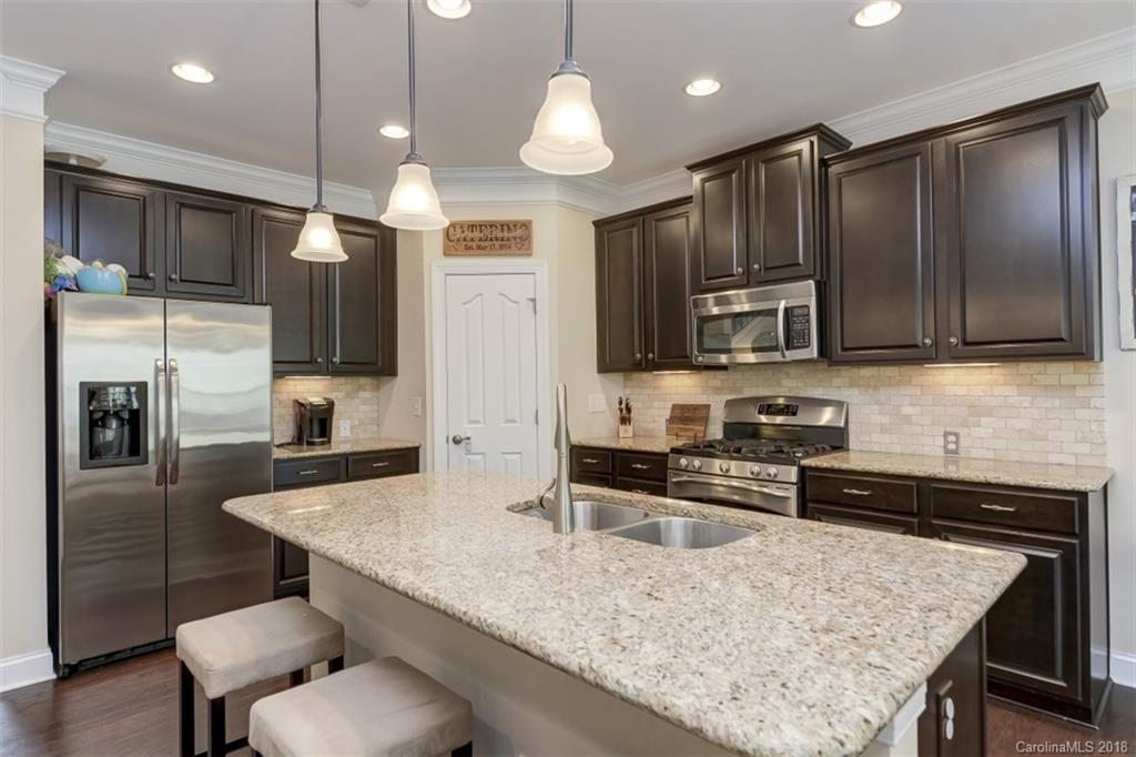 16834 Rudence Court Charlotte, NC 28278 - Photo 8 of 30 a kitchen with stainless steel appliances granite countertop a sink refrigerator and microwave