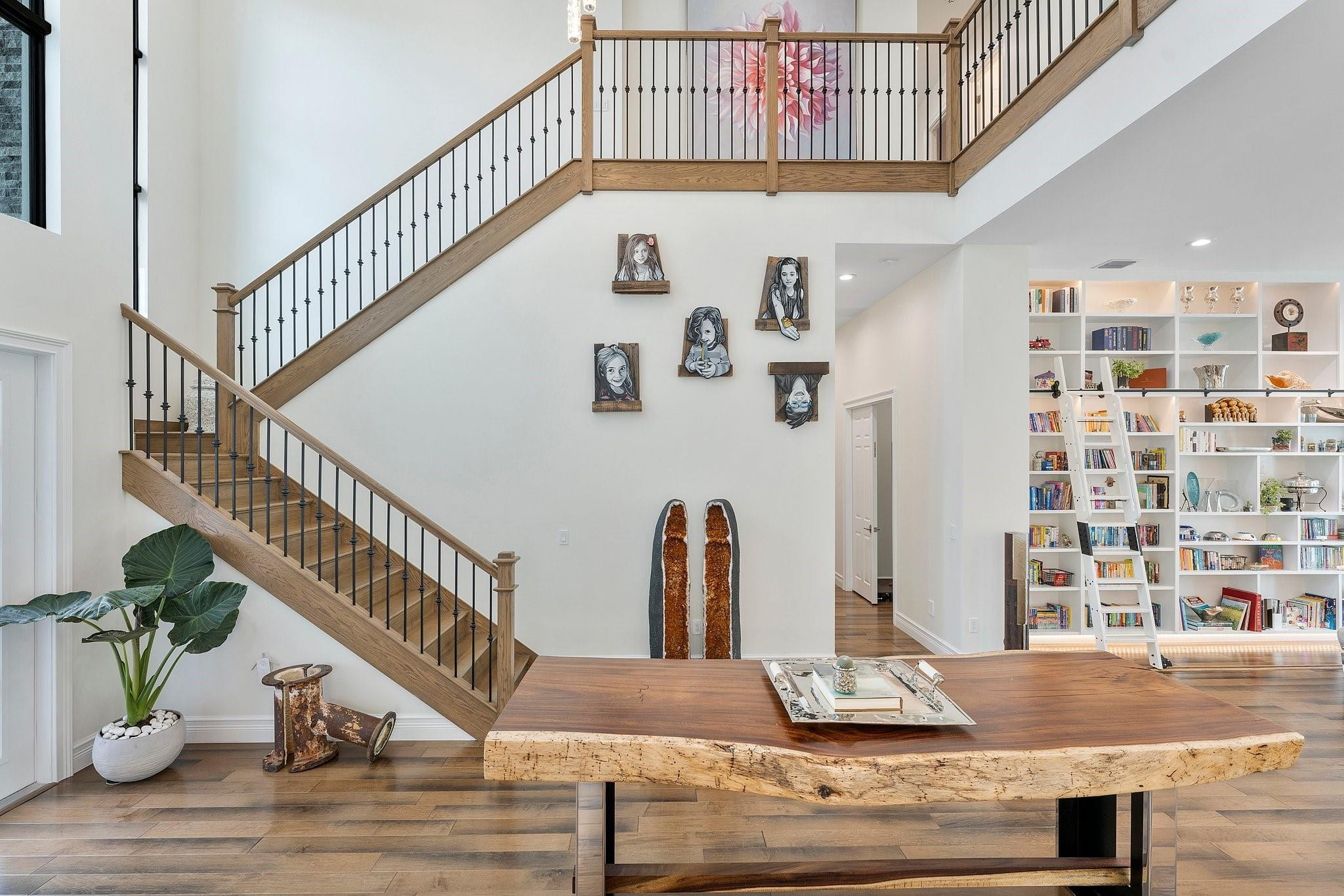 9626 Vescovato Way Boca Raton, FL 33496 - Photo 11 of 72 a view of staircase with lots of frames on wall and wooden floor