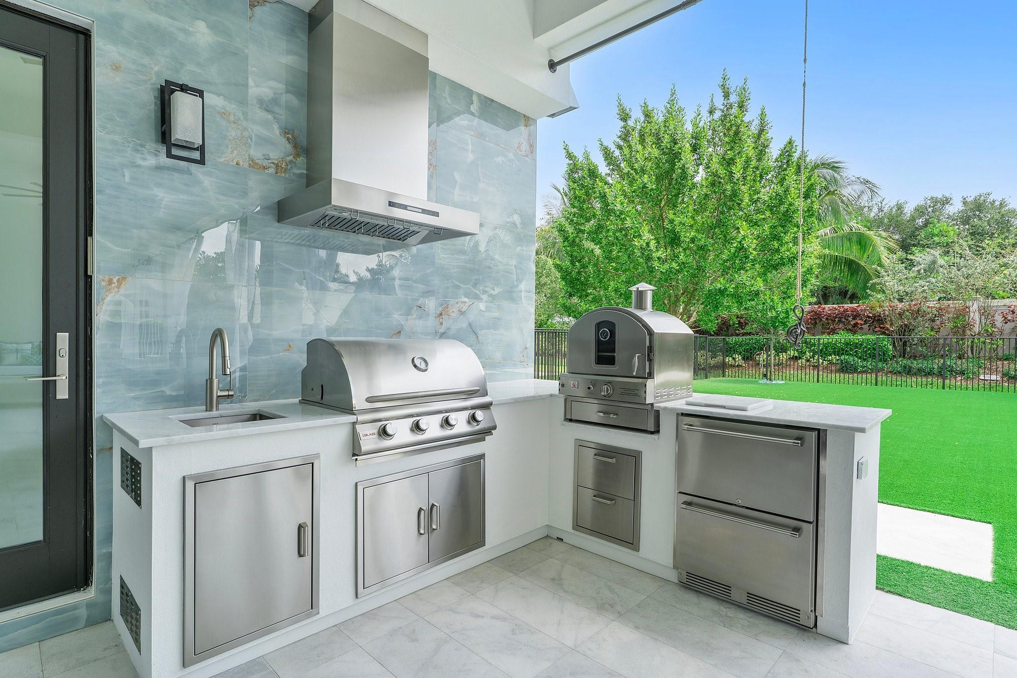 9626 Vescovato Way Boca Raton, FL 33496 - Photo 52 of 72 a kitchen with a stove and a refrigerator