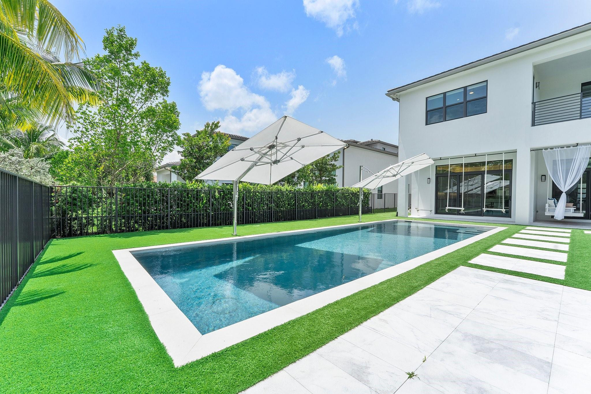 9626 Vescovato Way Boca Raton, FL 33496 - Photo 60 of 72 a view of a swimming pool with a yard