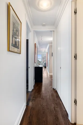 a view of a hallway with wooden floor