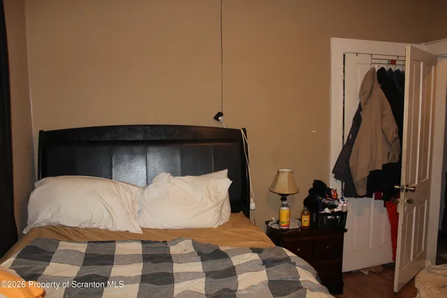 a bedroom with a bed and a television