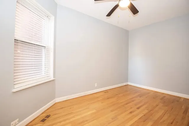 a view of a room with a window and ceiling fan