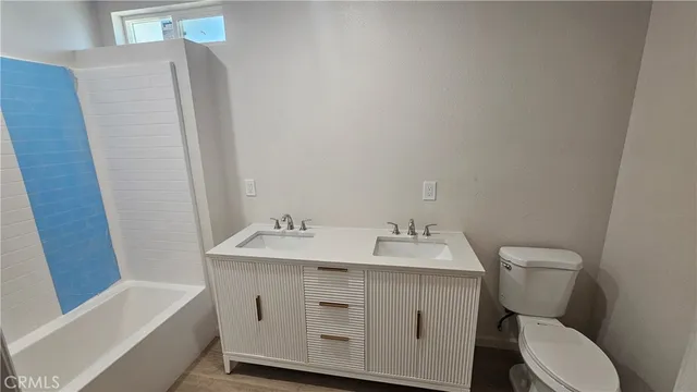 a bathroom with a sink toilet and tub