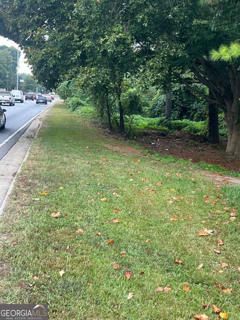 5160 Covington Highway, Unit 18 Decatur, GA 30035 - Photo 5 of 8 a view of a yard with potted plants and large trees