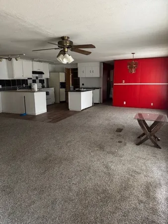a kitchen with a refrigerator and a stove