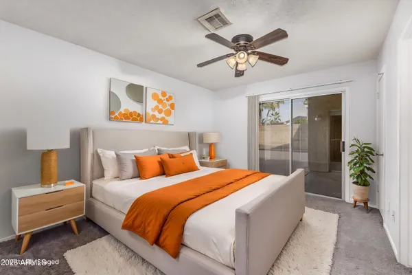 a bedroom with a bed and a potted plant