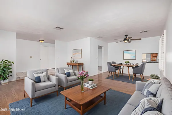 a living room with furniture and wooden floor