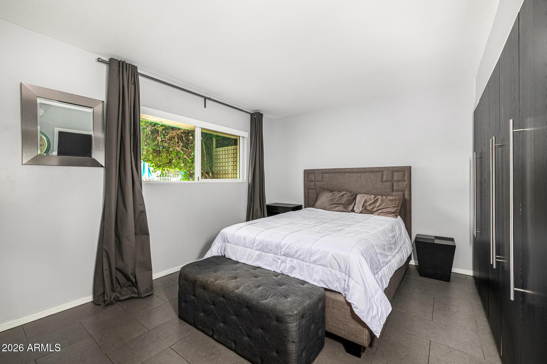 1107 West Osborn Road, Unit 118 Phoenix, AZ 85013 - Photo 14 of 18 a bedroom with a bed and a window