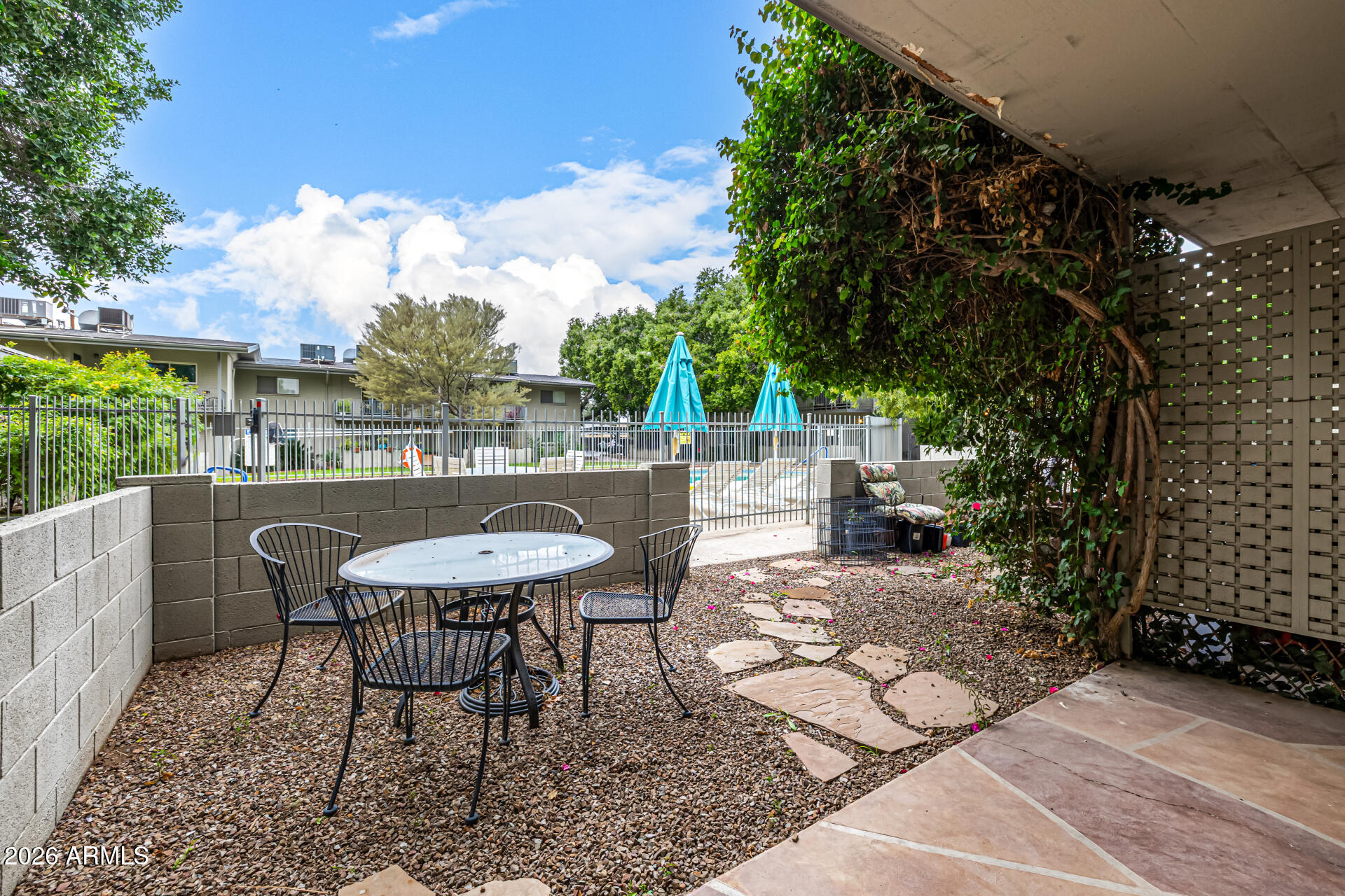 1107 West Osborn Road, Unit 118 Phoenix, AZ 85013 - Photo 3 of 18 a view of a chairs and table in the patio
