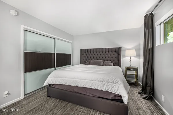 a bedroom with a bed and a walk in closet
