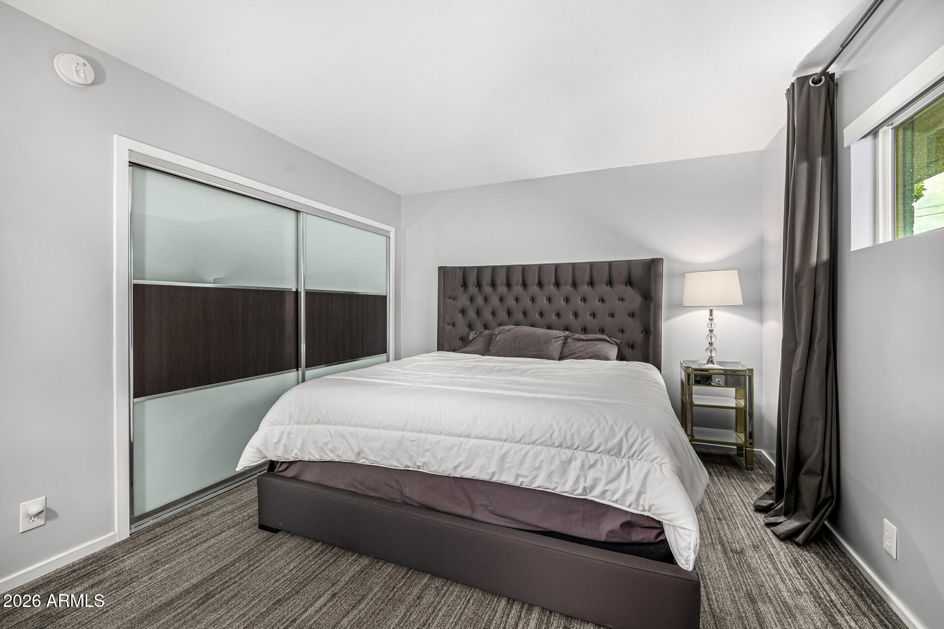 1107 West Osborn Road, Unit 118 Phoenix, AZ 85013 - Photo 9 of 18 a bedroom with a bed and a closet