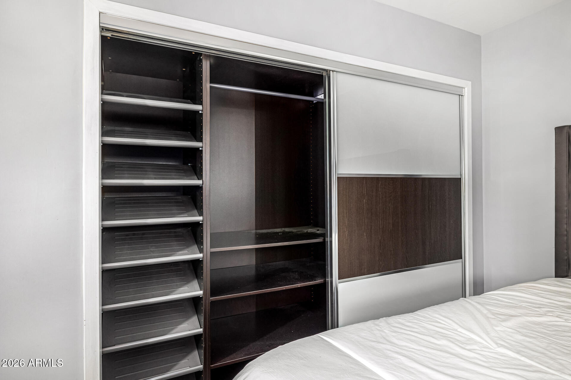 1107 West Osborn Road, Unit 118 Phoenix, AZ 85013 - Photo 10 of 18 a bedroom with a bed and a walk in closet