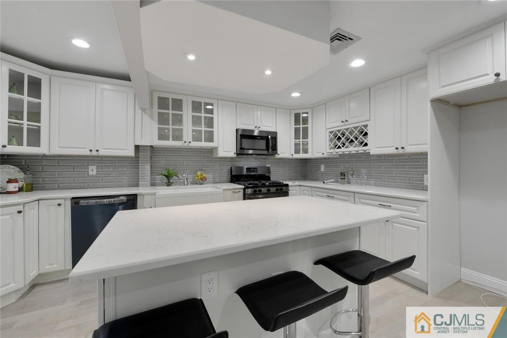 18 Old Ridge Road Monmouth Junction, NJ 08852 - Photo 7 of 25 a kitchen with a sink a stove and cabinets