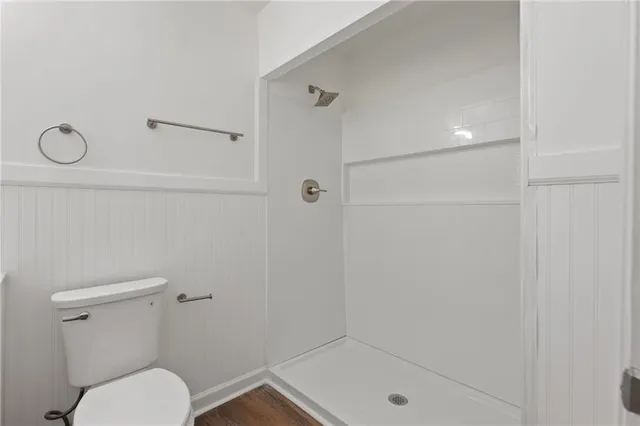 a bathroom with a shower a toilet and a sink