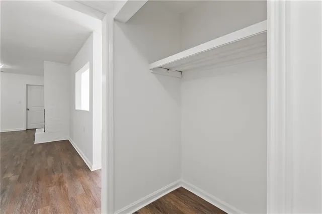 a view of a small space with wooden floor and closet