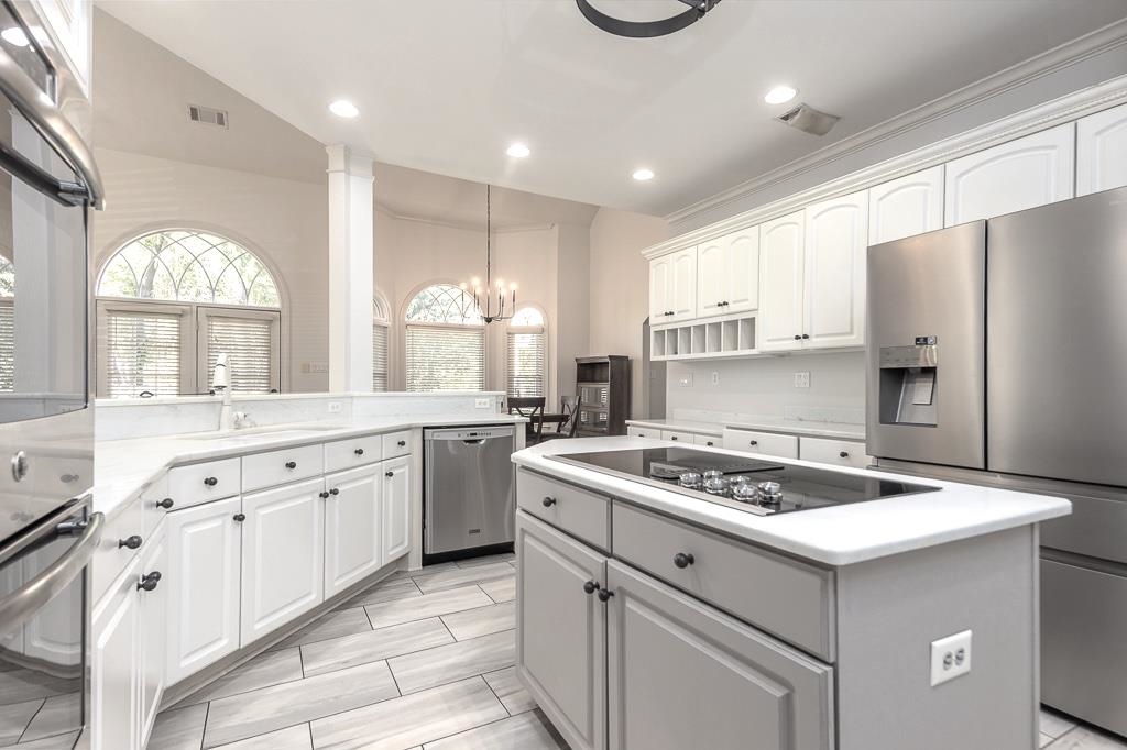 1893 Hartwell Manor West Collierville, TN 38017 - Photo 13 of 40 a kitchen with granite countertop a sink stove a refrigerator and white cabinets with wooden floor
