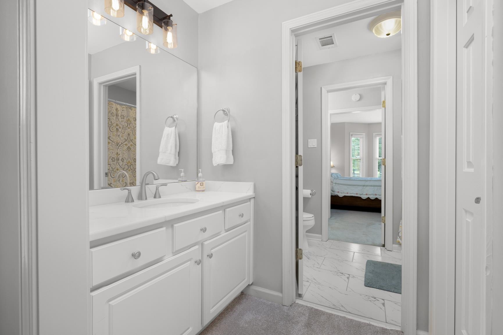 1893 Hartwell Manor West Collierville, TN 38017 - Photo 28 of 40 Full bath featuring light marble finish flooring, vanity, ensuite bathroom, and a shower with curtain