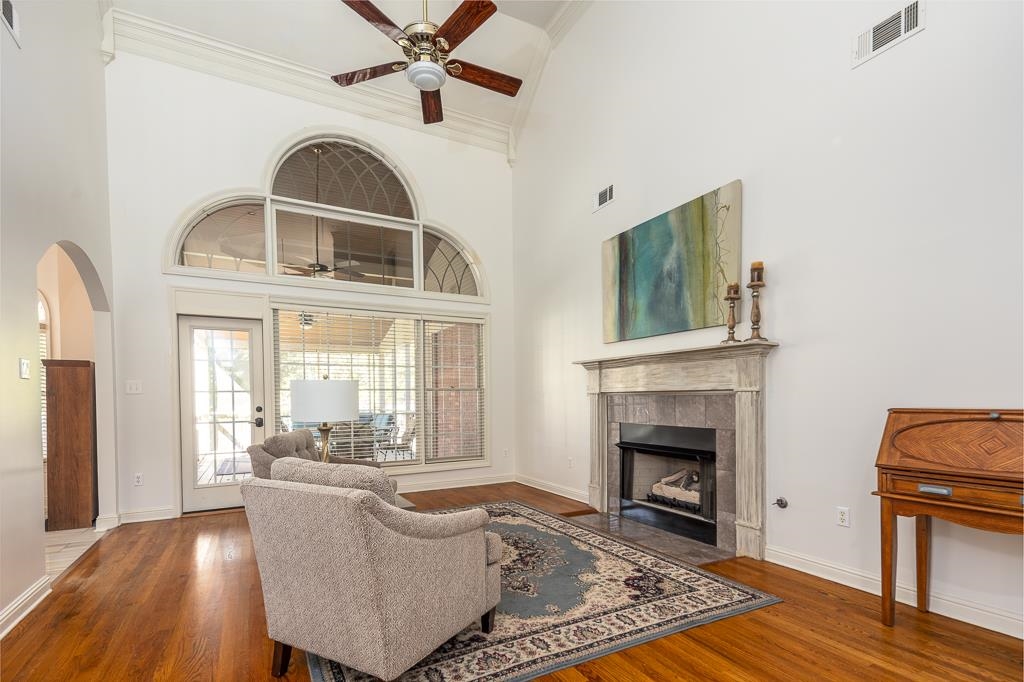 1893 Hartwell Manor West Collierville, TN 38017 - Photo 8 of 40 Living room with ceiling fan, ornamental molding, dark wood-type flooring, a fireplace, and a high ceiling