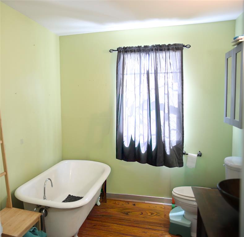 1500 Bonham Street Commerce, TX 75428 - Photo 23 of 29 a bathroom with a sink and a mirror