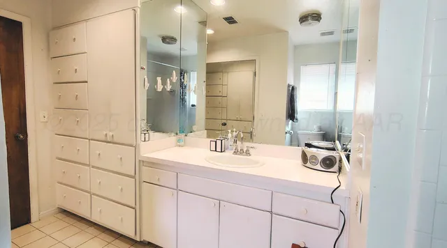 a bathroom with a double vanity sink mirror and