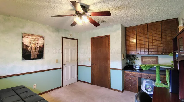 a view of livingroom with furniture and a fan