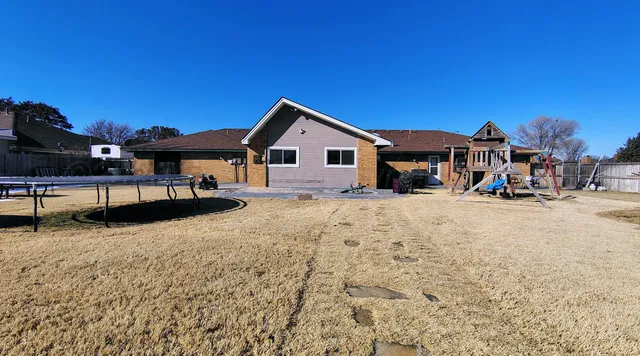 a view of a house with snow on the side of the road