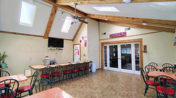 a backyard of a house with table and chairs