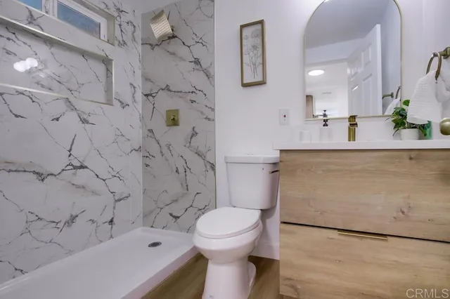 a bathroom with a sink toilet and shower