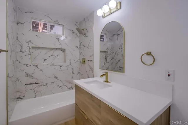 a view of a hallway with wooden floor and a living room