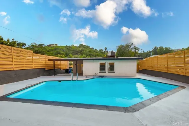 swimming pool with outdoor seating and yard