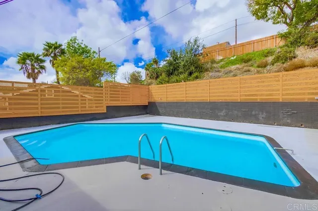 a view of a swimming pool with an outdoor seating and a yard