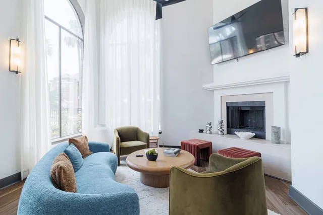 a living room with furniture a fireplace and a flat screen tv