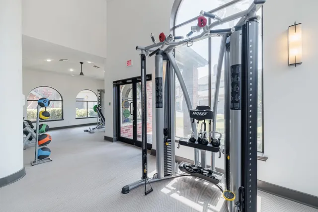 a view of a hallway with couch and chandelier