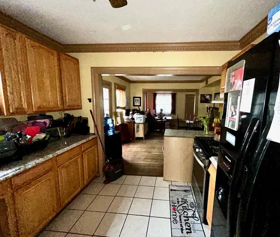 a living room with furniture a flat screen tv and a floor to ceiling window